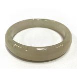 A Chinese pale celadon jade bangle of plain form, diameter 7.5cm.