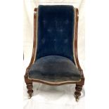 A Victorian mahogany framed blue velvet button-back upholstered chair.