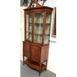 A good early 20th century Sheraton Revival fiddle mahogany display cabinet of serpentine form, the