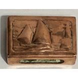 Newlyn copper matchbox embossed with a sailing boat and lighthouse, the reverse with monogram, width