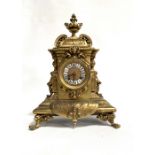 French gilt brass cased mantel clock, the ornate cast case with urn finial, the 3in gilt dial with
