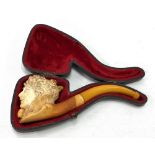 A 19th century Meerschaum pipe, the bowl carved as a lady's head and with amber mouthpiece, within