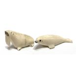 Two Inuit carved walrus tusk figures, one a seal the other a walrus, both signed, length of seal 9.