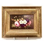 A small rectangular painted ceramic floral decorated panel, within modern frame, 12.5 x 8cm.