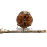 A white and rose coloured metal bombilla Yerba mate drinking straw and gourd with similar white
