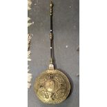 Antique brass and steel handled bedwarming pan, the pan embossed with a central circular portrait