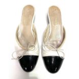 A pair of ladies Chanel shoes, white leather and black patent mules with kitten heel, size 39,
