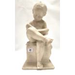 An Italian carved alabaster sculpture of a nude boy reading, the back signed P. Conti Firenze,