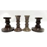 Two pairs of Cornish red turned serpentine candlesticks, the tallest 12.5cm.