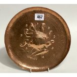 Newlyn copper dish with planished decoration and embossed with a fish amongst kelp, stamped