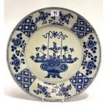 A Chinese export blue and white underglaze decorated dish, decorated to the centre with a vase