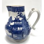 An 18th century Chinese export blue and white sparrow beak jug decorated with a pagoda lake