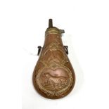 A copper and brass powder flask, embossed to both sides with hounds and birds, length 15.5cm.