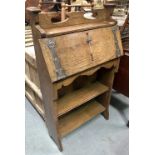 Arts and Crafts oak small bureau with copper embossed strapwork hinged to reveal a single drawer and
