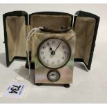Miniature mother of pearl cased travel alarm clock with carrying handles and two dials and within
