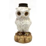 A German porcelain owl oil lamp base set with glass eyes, height 17cm.