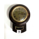 Small oak cased drop dial single train wall clock, the 4in brass dial with Roman numerals within