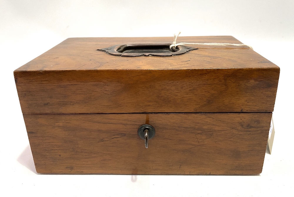 A Victorian walnut jewellery box with recessed handle to the lid, enclosing a fitted interior, width