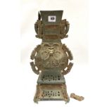 A Chinese bronze square section ritual vessel, Hu Zhou Dynasty style with stylised animal head