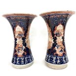 A pair of Chinese Imari flared vases decorated with panels of dragons, Ho Ho birds and pagoda