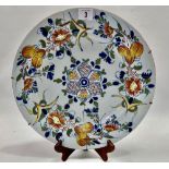 An 18th century English Delft dish decorated with floral sprays, diameter 33.5cm (AF).