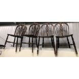 Set of four elm seat wheel back kitchen chairs.