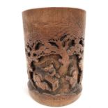 A Chinese bamboo carved brush pot, decorated with three sages underneath trees, height 16cm.