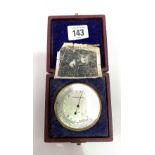 A G.P.O. compensated pocket barometer with silvered dial and brass lacquered case, stamped No.1A AJC