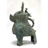 A Chinese Zhou Dynasty style bronze vessel modelled as a mythical creature, with loop handle, lid
