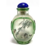 A Chinese green overlay glass reverse painted scent bottle, one side painted a landscape, the