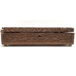 A late 19th century Anglo Indian carved hinge lidded box, the lid carved with a seated gentleman and