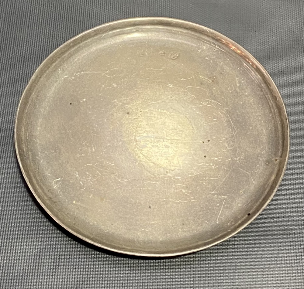 Continental white metal circular card tray, raised on three ball feet, indistinct marks, diameter