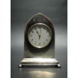 Edwardian silver miniature timepiece by Henry Williamson Ltd, the case of lancet form raised on four