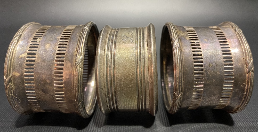 Pair of silver pierced napkin rings; together with one other napkin ring (3), weight 1.95oz approx.