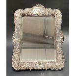 Edwardian silver mounted rectangular bevel edged mirror, the mount with foliate scrolls,