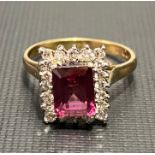 18ct hallmarked gold tourmaline and diamond cluster ring, the emerald cut tourmaline of 8x6mm