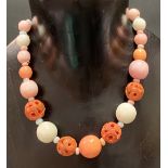 Coral bead necklace with base metal clasp, the largest bead of 18mm diameter approx, four beads