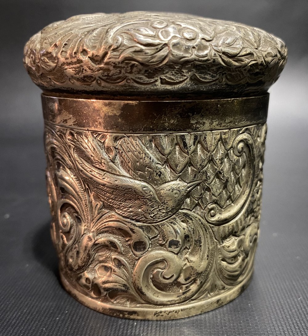 Victorian silver cylindrical lidded box, foliate scroll embossed and with a bird and serpent,