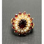 9ct gold ruby and pearl set cluster ring, the central ruby of 0.75ct spread approx, weight 5.5g