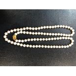 A pearl necklace with gold clasp marked 585, 7mm diameter, length 73.5cm.