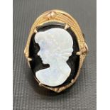Israeli 14ct gold ring set with oval onyx and applied with an opal profile portrait of a woman,