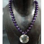 A modern amethyst and white metal facet cut bead necklace with pendant.