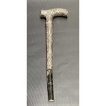 White metal embossed weighted parasol handle, length of silver handle 18cm (af).