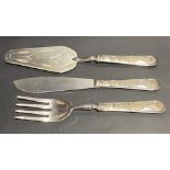 Silver weighted handled fish serving set comprising fork, slice and server, the handles embossed