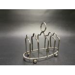 George V silver four section wire toast rack on four ball feet, maker WA, Birmingham 1911, width