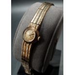 9ct gold ladies Omega bracelet cocktail watch, the 11mm dial signed Omega and with baton markers,