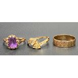 Three 9ct gold rings, one a band ring, the other set an amethyst, the other with two citrines,