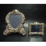 Modern silver mounted picture frame with heart shaped aperture embossed with cherubs and foliate