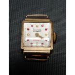 18ct gold cased ladies manual wind cocktail watch, the square 14mm dial with pick and yellow gem