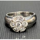 A modern 18ct white gold diamond cluster daisy ring, the central diamond of 0.20ct spread approx,